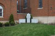 Wider view of the memorial in front of the former rectory at 3808 W. Iowa.